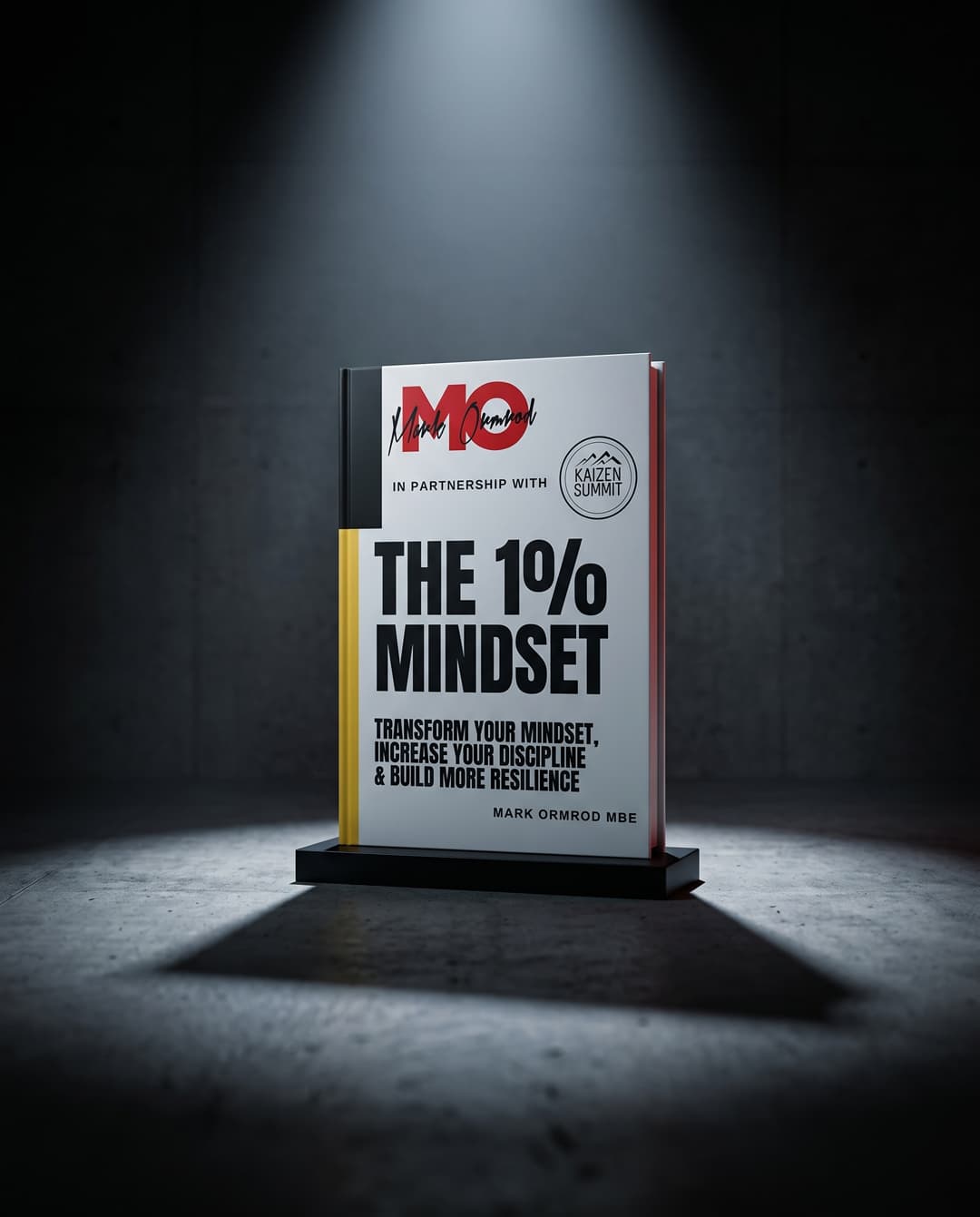 The 1% Mindset book cover — white cover with the MO monogram and Kaizen Summit mark, standing under a spotlight